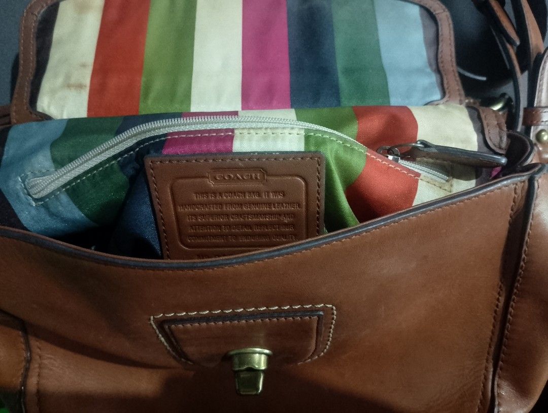 Coach Leather Handbag with Tassel Charm (Category: Luxury Bags & Wallets) located in Manila. Submitted by silenttiger-e0e3 (Listing ID 1444162647, Image 2). Description: - Genuine brown leather Coach bag - Eye-catching colorful striped interior lining - Includes a detachable shoulder strap for versatile wear - Adorned with a stylish tassel charm and signature Coach logo tag - Secure turn-lock closure - Minor signs of wear on the leather tag, over