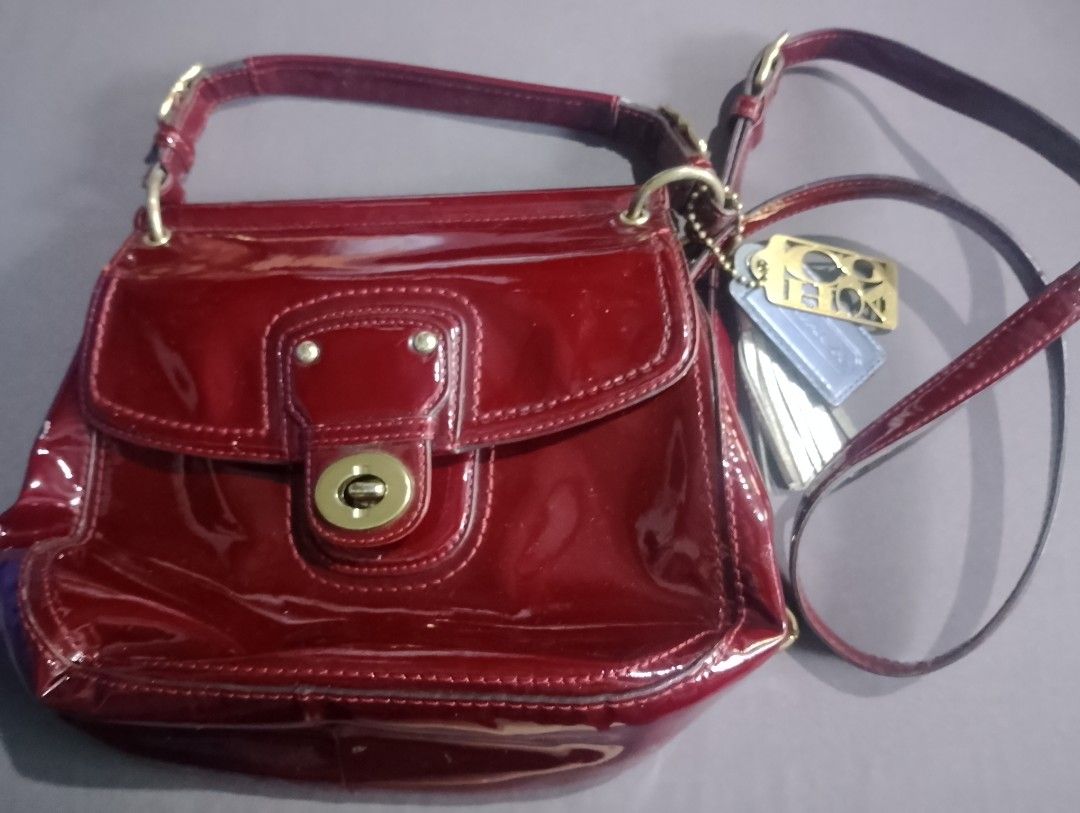 Coach Patent Leather Handbag - Red (Category: Luxury Bags & Wallets) located in Manila. Submitted by silenttiger-e0e3 (Listing ID 1444162774, Image 2). Description: - Genuine red patent leather Coach handbag - Secure turn-lock closure on front flap - Detachable shoulder strap for versatile carrying - Authentic Coach hang tags included - Ideal for both daily errands and evening events.