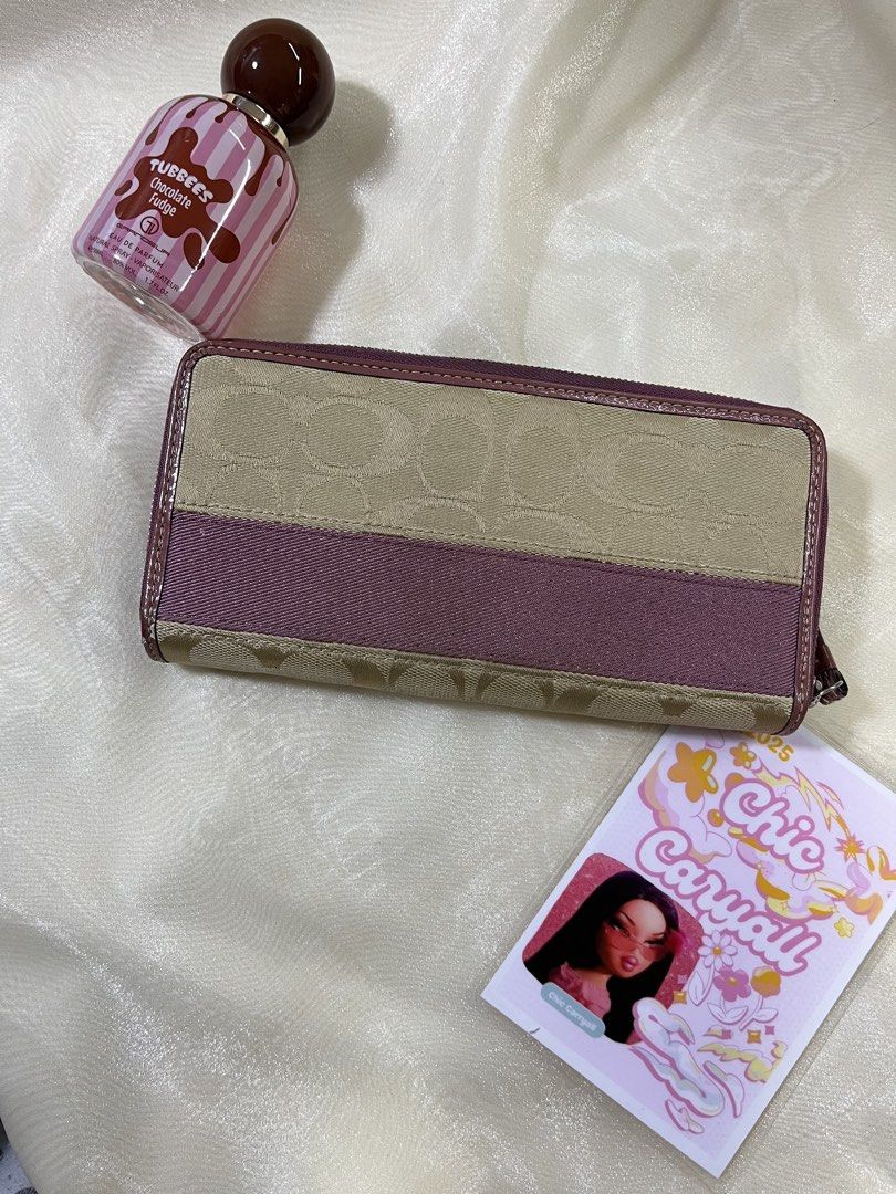 Coach Pink Wallet (Category: Luxury Bags & Wallets) located in Manila. Submitted by chiccarryall (Listing ID 1444252475, Image 2). Description: READ FIRST ‼️ - With signs of usage: with minimal color transfer unnoticeable - Authentic Coach wallet - Signature C pattern in tan canvas - Pink stripe and trim - Multiple interior card slots and bill compartments - Zippered coin pocket Kindly view detailed photos before purchase. I am selling pre loved 