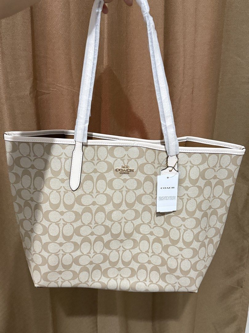 Coach Signature Canvas Tote Bag (Category: Luxury Bags & Wallets) located in Balanga. Submitted by gnibfacs (Listing ID 1444230055, Image 1). Description: - Classic Coach tote bag - Beige and brown signature 'C' print - White trim and handles - Brand new with original tags attached - Spacious interior, ideal for daily use or travel - Versatile for all your essentials.