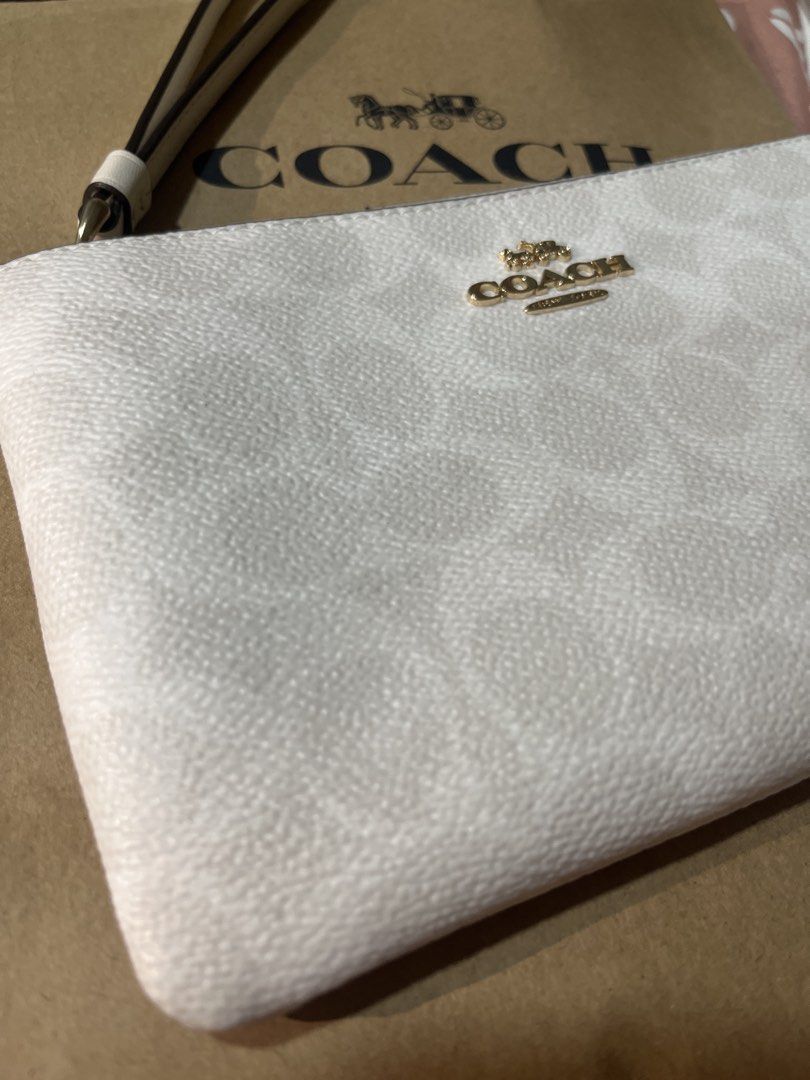 Coach Signature Zip Wristlet White (Category: Luxury Bags & Wallets) located in Manila. Submitted by ysa.declutters1 (Listing ID 1444248215, Image 3). Description: - Authentic Coach wristlet - White signature print - Gold hardware - Zip closure - Detachable wrist strap - Perfect for essentials - Purchased in Canada - Original tags and receipt available.