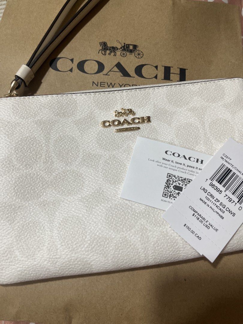 Coach Signature Zip Wristlet White (Category: Luxury Bags & Wallets) located in Manila. Submitted by ysa.declutters1 (Listing ID 1444248215, Image 2). Description: - Authentic Coach wristlet - White signature print - Gold hardware - Zip closure - Detachable wrist strap - Perfect for essentials - Purchased in Canada - Original tags and receipt available.