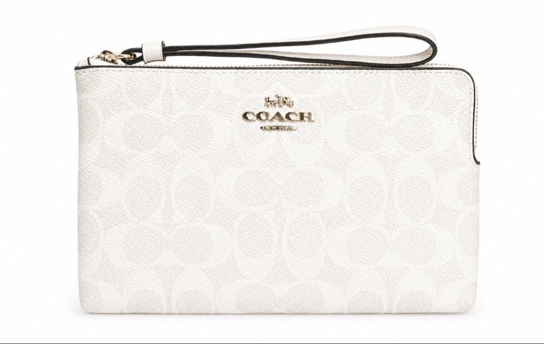 Coach Signature Zip Wristlet White (Category: Luxury Bags & Wallets) located in Manila. Submitted by ysa.declutters1 (Listing ID 1444248215, Image 1). Description: - Authentic Coach wristlet - White signature print - Gold hardware - Zip closure - Detachable wrist strap - Perfect for essentials - Purchased in Canada - Original tags and receipt available.