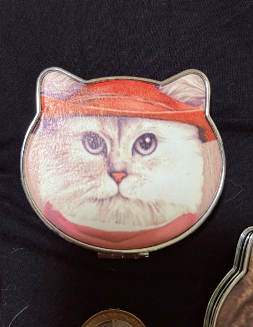 Cute Cat Face Compact Mirror ₱150 each (Category: Face Care) located in Manila. Submitted by yourtoothfairy (Listing ID 1444225083, Image 3). Description: - cat face folding compact mirror - Each mirror features a unique cat leatherette photo on the lid. - Compact and portable size, ideal for on-the-go touch-ups. - Silver interior mirror. - Makes a purr-fect accessory for any cat lover!😻.