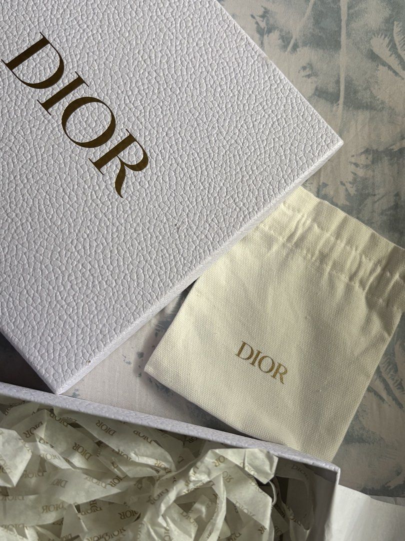 Dior Gift Box with Pouch and Tissue Paper (Category: Luxury Accessories) located in Cebu City. Submitted by yela_. (Listing ID 1444172527, Image 3). Description: - Authentic Dior packaging set - Includes white textured gift box, drawstring pouch, and branded tissue paper - Gift box has a small mark on the corner - Perfect for gifting or storing small items - All items are authentic Dior.