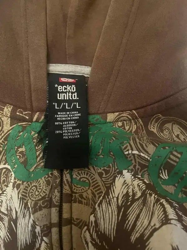 Ecko Unltd. Brown Zip-Up Hoodie (Category: Hoodies) located in Manila. Submitted by ixgri (Listing ID 1444260983, Image 2). Description: - Brand: Ecko Unltd. - Color: Brown - Style: Zip-up hoodie - Size: L - Features: Large graphic print on front with rhinos and green lettering - Material: Cotton and polyester blend - Best for: Casual wear.