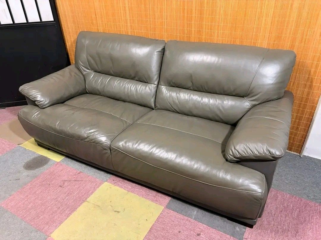 Grey Leather 2-Seater Sofa (Category: Sofas) located in Manila. Submitted by eloizavill76462 (Listing ID 1444129216, Image 2). Description: Modern 3-Seater Leather Sofa BIG & BULKY!!! SOFT & COMFY!!! THICK GENUINE LEATHER!!! 77L x 38W x 16H seat height inches Sandalan height 35 inches In good condition.