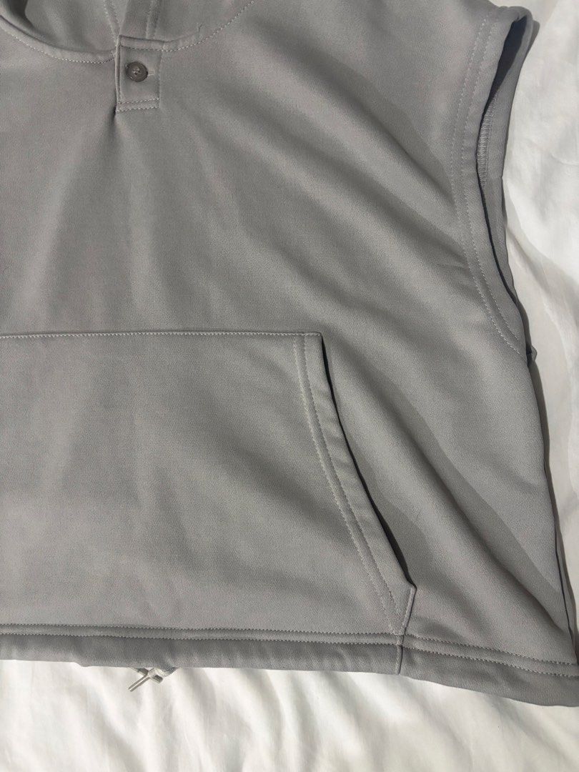 Grey Sleeveless Hoodie with Pocket and Drawstring (Category: Coats, Jackets and Outerwear) located in Manila. Submitted by thriftgodesa (Listing ID 1444276283, Image 3). Description: - Grey sleeveless hoodie - Features a front pocket - Drawstring at the hem for adjustable fit - Button closure at the neck - Ideal for layering or casual outfits - Simple and versatile design.