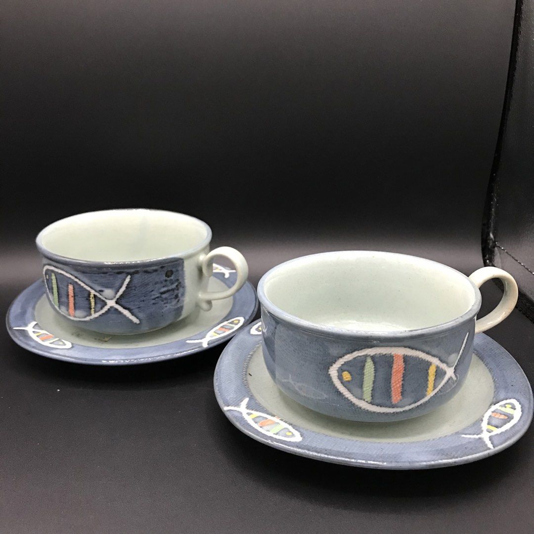 Handmade Ceramic Fish Design Cup and Saucer Set (Category: Coffee & Tea Tableware) located in Baao. Submitted by all.things.japan (Listing ID 1444205552, Image 1). Description: - Set of 2 handmade ceramic cups with matching saucers. - Features charming fish design with colorful stripes. - Beautiful blue and grey toned glaze. - Perfect for enjoying your morning coffee or tea. - Great addition for unique pottery collectors..