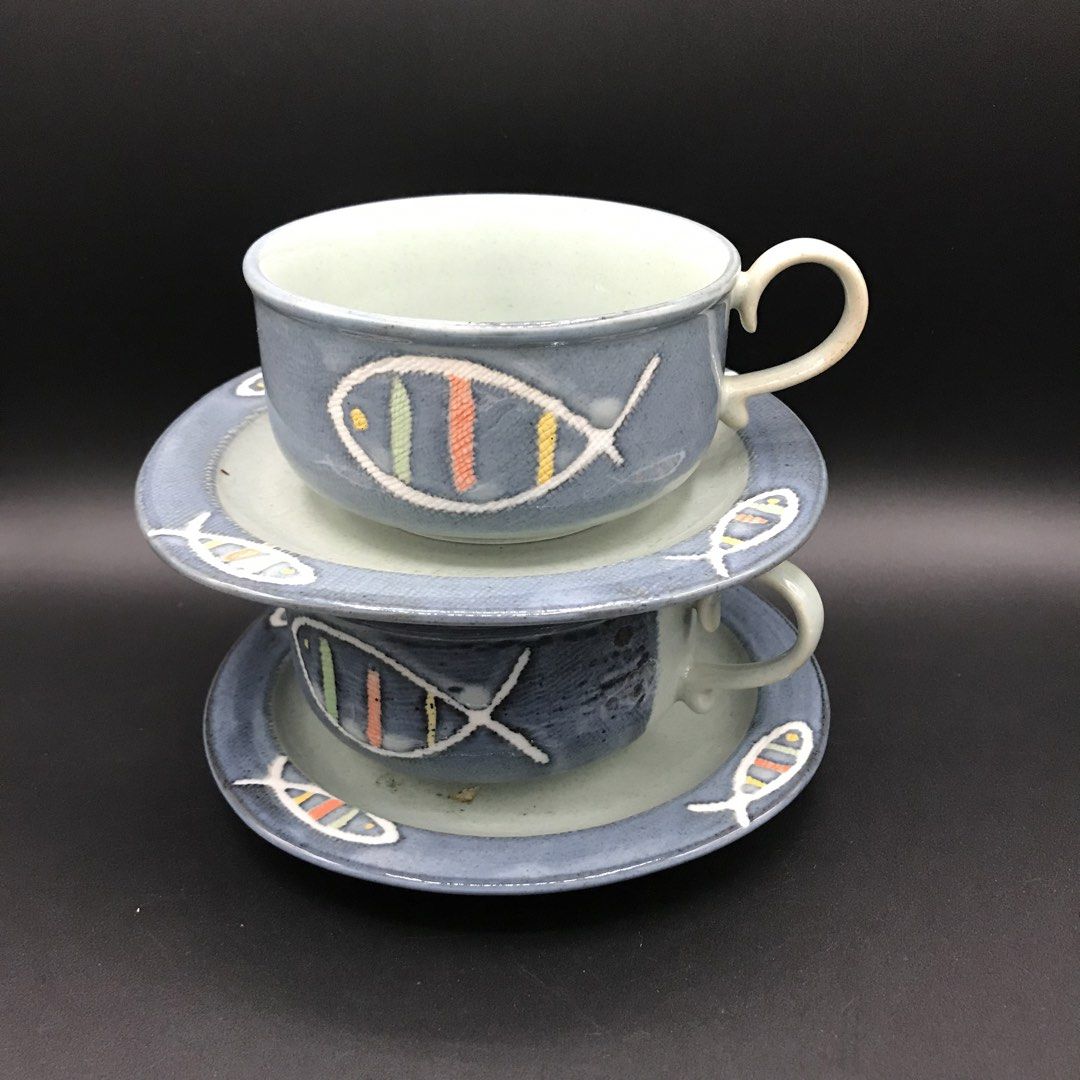 Handmade Ceramic Fish Design Cup and Saucer Set (Category: Coffee & Tea Tableware) located in Baao. Submitted by all.things.japan (Listing ID 1444205552, Image 2). Description: - Set of 2 handmade ceramic cups with matching saucers. - Features charming fish design with colorful stripes. - Beautiful blue and grey toned glaze. - Perfect for enjoying your morning coffee or tea. - Great addition for unique pottery collectors..