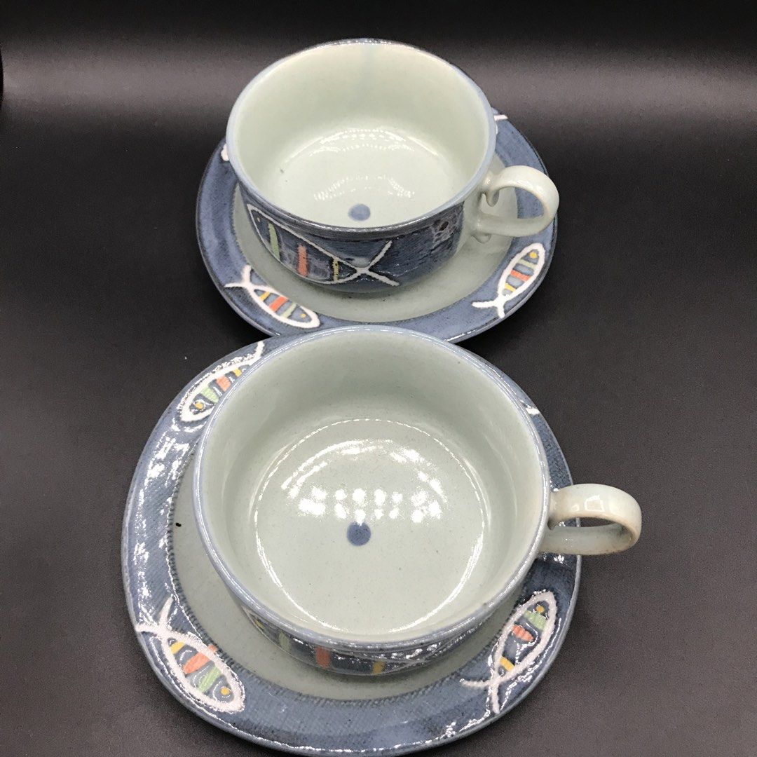 Handmade Ceramic Fish Design Cup and Saucer Set (Category: Coffee & Tea Tableware) located in Baao. Submitted by all.things.japan (Listing ID 1444205552, Image 3). Description: - Set of 2 handmade ceramic cups with matching saucers. - Features charming fish design with colorful stripes. - Beautiful blue and grey toned glaze. - Perfect for enjoying your morning coffee or tea. - Great addition for unique pottery collectors..