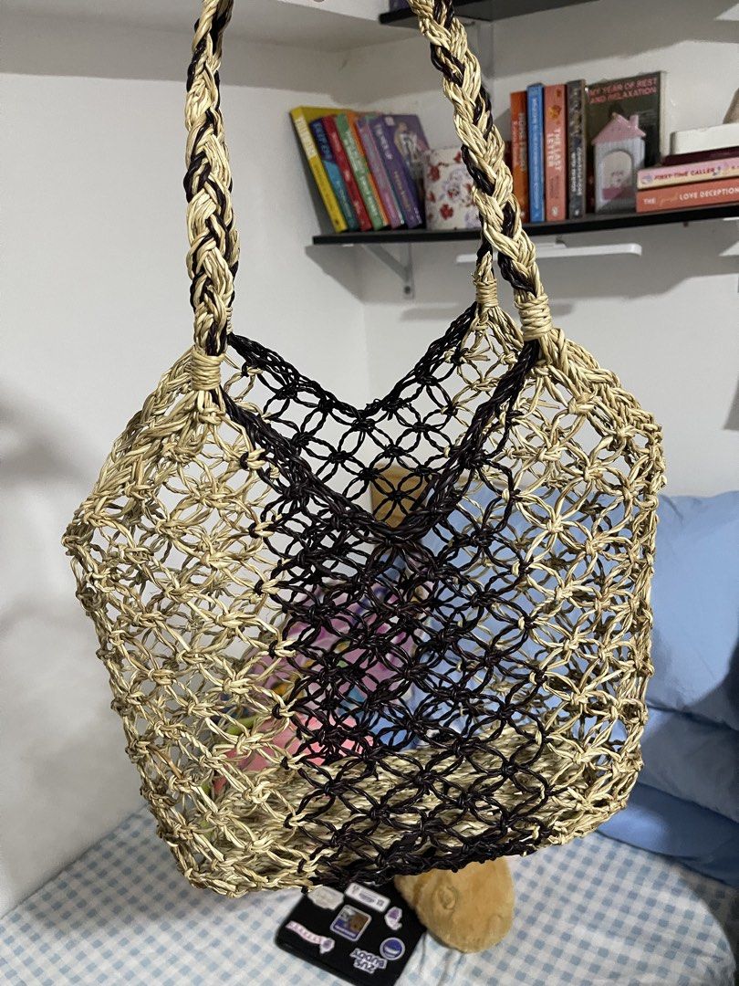 Handwoven Macrame Tote Bag (Category: Tote Bags) located in Mandaluyong City. Submitted by ynsbf (Listing ID 1444250706, Image 1). Description: - Stylish woven tote bag - Natural straw color with black accents - Braided straps for comfortable carrying - Ideal for beach days or everyday errands - Spacious interior for essentials - Unique handmade aesthetic 💗 Got this from a souvenir shop @ Boracay! Never used I just made it a room display 😃 .