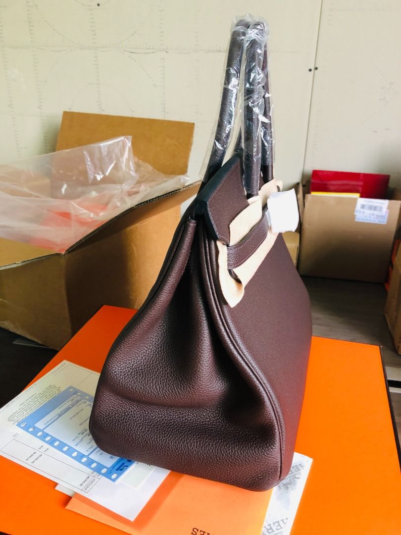 Hermes Birkin Dark Brown Leather Handbag (Category: Luxury Bags & Wallets) located in Paranaque City. Submitted by daneauassc54982 (Listing ID 1444122286, Image 3). Description: - Authentic dark brown leather Hermes Birkin bag - Handles still wrapped in original plastic - Comes with original packaging - Includes authenticity papers - Classic and timeless design - Perfect for any occasion.