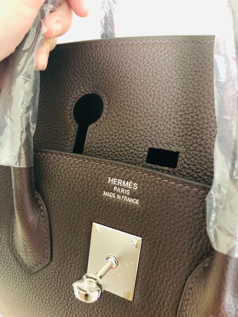 Hermes Birkin Dark Brown Leather Handbag (Category: Luxury Bags & Wallets) located in Paranaque City. Submitted by daneauassc54982 (Listing ID 1444122286, Image 2). Description: - Authentic dark brown leather Hermes Birkin bag - Handles still wrapped in original plastic - Comes with original packaging - Includes authenticity papers - Classic and timeless design - Perfect for any occasion.
