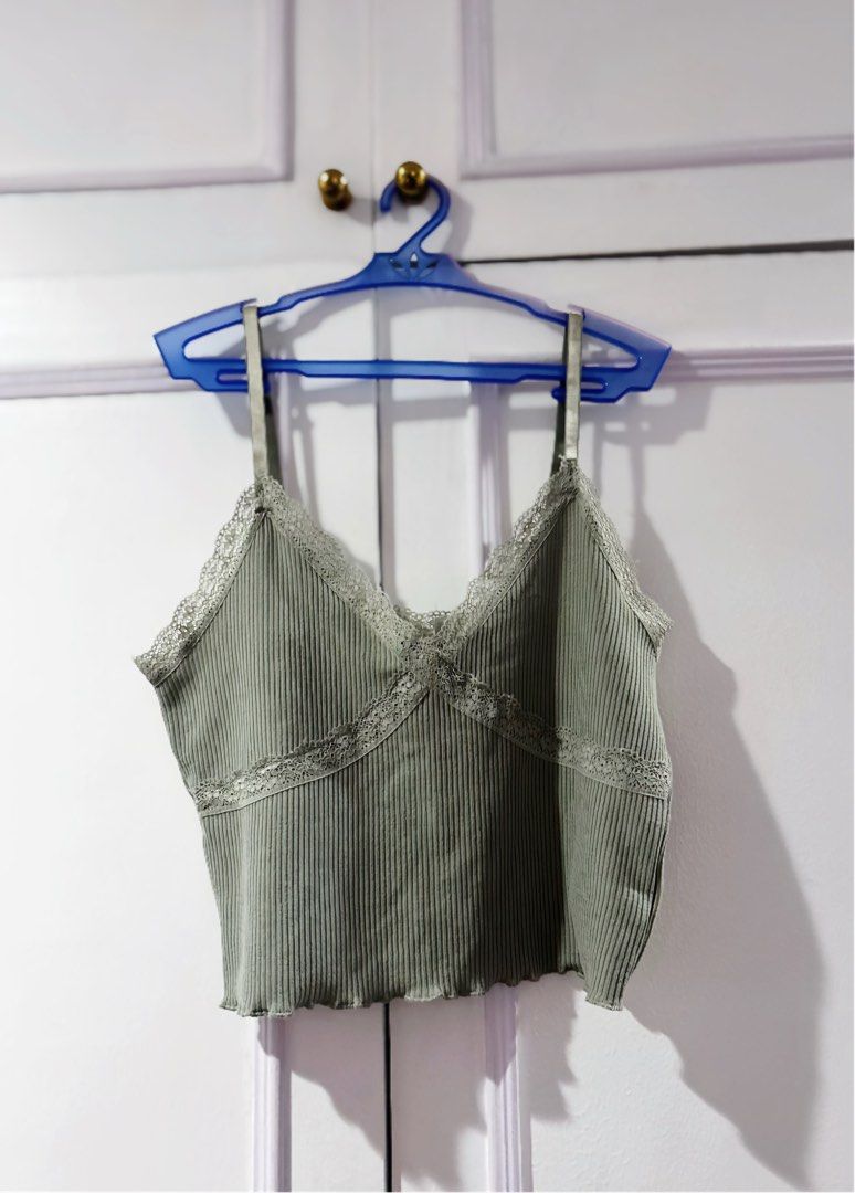 H&M Ribbed Lace Trim Cami Top M (Category: Sleeveless) located in Manila. Submitted by jngrc (Listing ID 1444218892, Image 1). Description: - Sage green ribbed cami top - Brand: H&M - Size: Medium (M) - Details: Lace trim on neckline and hem - Features: Adjustable spaghetti straps - Style: Cropped length.