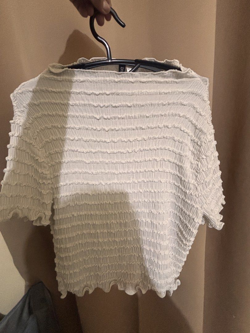 H&MWhite Smocked Cropped Top with Lettuce Hem (Category: Blouses) located in Pasig City. Submitted by xandraaamia (Listing ID 1444259199, Image 1). Description: - Cute white cropped top - Smocked texture all over - Lettuce hem on sleeves and bottom - Very stretchy and comfortable - Pairs well with high-waisted bottoms - Ideal for casual outings.