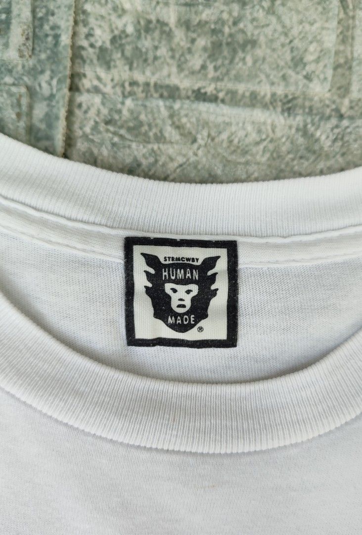 Human Made Happiness T-Shirt (Category: Tshirts & Polo Shirts ) located in Bayambang. Submitted by mon10192816 (Listing ID 1444260175, Image 3). Description: - Width 18¾ - Lenght 25 - Brand: Human Made - Color: White - Graphic: "Emergency Service Unit Happiness" on front and back - Features: Human Made logo tag - Origin: Made in Japan - Style: Perfect for streetwear collections.