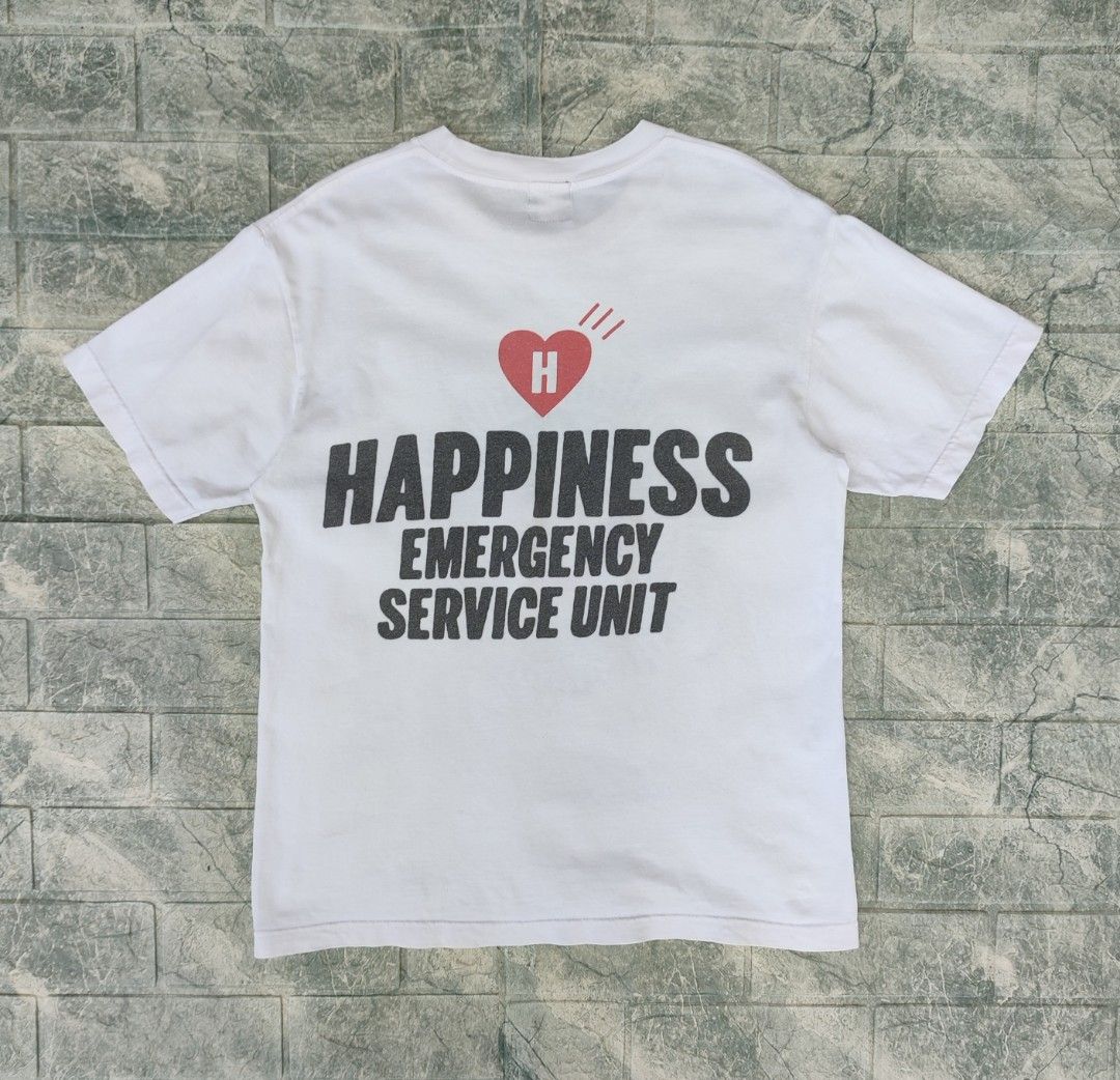 Human Made Happiness T-Shirt (Category: Tshirts & Polo Shirts ) located in Bayambang. Submitted by mon10192816 (Listing ID 1444260175, Image 2). Description: - Width 18¾ - Lenght 25 - Brand: Human Made - Color: White - Graphic: "Emergency Service Unit Happiness" on front and back - Features: Human Made logo tag - Origin: Made in Japan - Style: Perfect for streetwear collections.