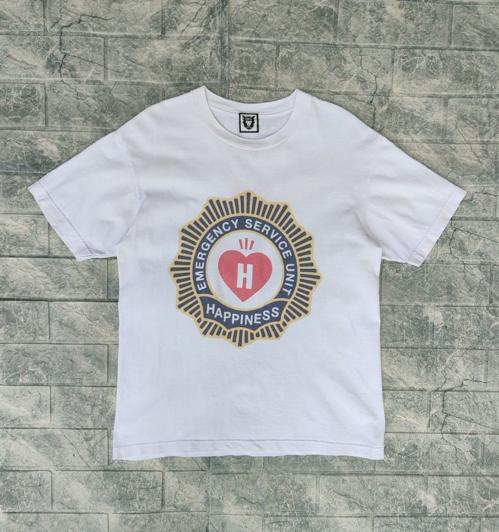 Human Made Happiness T-Shirt (Category: Tshirts & Polo Shirts ) located in Bayambang. Submitted by mon10192816 (Listing ID 1444260175, Image 1). Description: - Width 18¾ - Lenght 25 - Brand: Human Made - Color: White - Graphic: "Emergency Service Unit Happiness" on front and back - Features: Human Made logo tag - Origin: Made in Japan - Style: Perfect for streetwear collections.