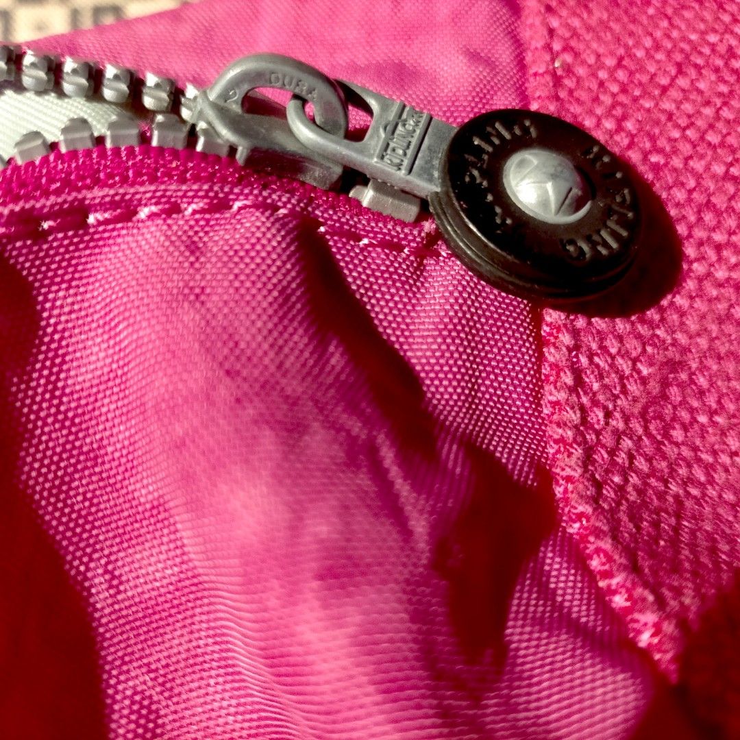 Kipling tote bag in vibrant pink nylon (Category: Luxury Bags & Wallets) located in Taguig. Submitted by agenttin (Listing ID 1444209759, Image 3). Description: Brand: Kipling Material: Known for its signature crinkle nylon Color: Bright Fuchsia/Pink Features: Includes a matching furry monkey charm and sturdy canvas straps.