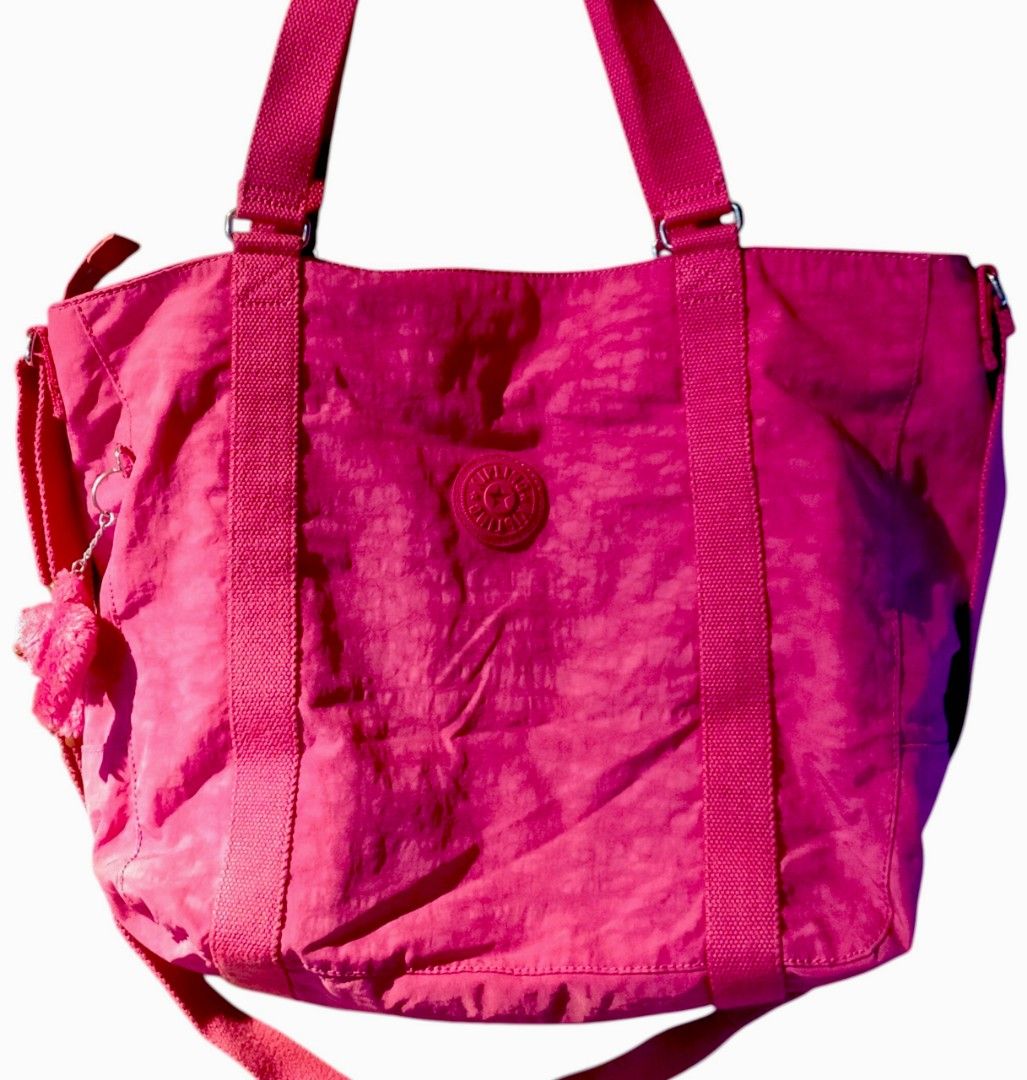 Kipling tote bag in vibrant pink nylon (Category: Luxury Bags & Wallets) located in Taguig. Submitted by agenttin (Listing ID 1444209759, Image 1). Description: Brand: Kipling Material: Known for its signature crinkle nylon Color: Bright Fuchsia/Pink Features: Includes a matching furry monkey charm and sturdy canvas straps.