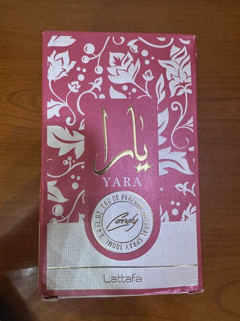 Lattafa Yara Candy Eau de Parfum Natural Spray 100ml (Category: Fragrance & Deodorants) located in Manila. Submitted by whitewallflower (Listing ID 1444179676, Image 1). Description: - Yara Candy perfume by Lattafa - 100ml natural spray - Features a beautiful pink floral box design - Ingredients listed on the side - Made in UAE.