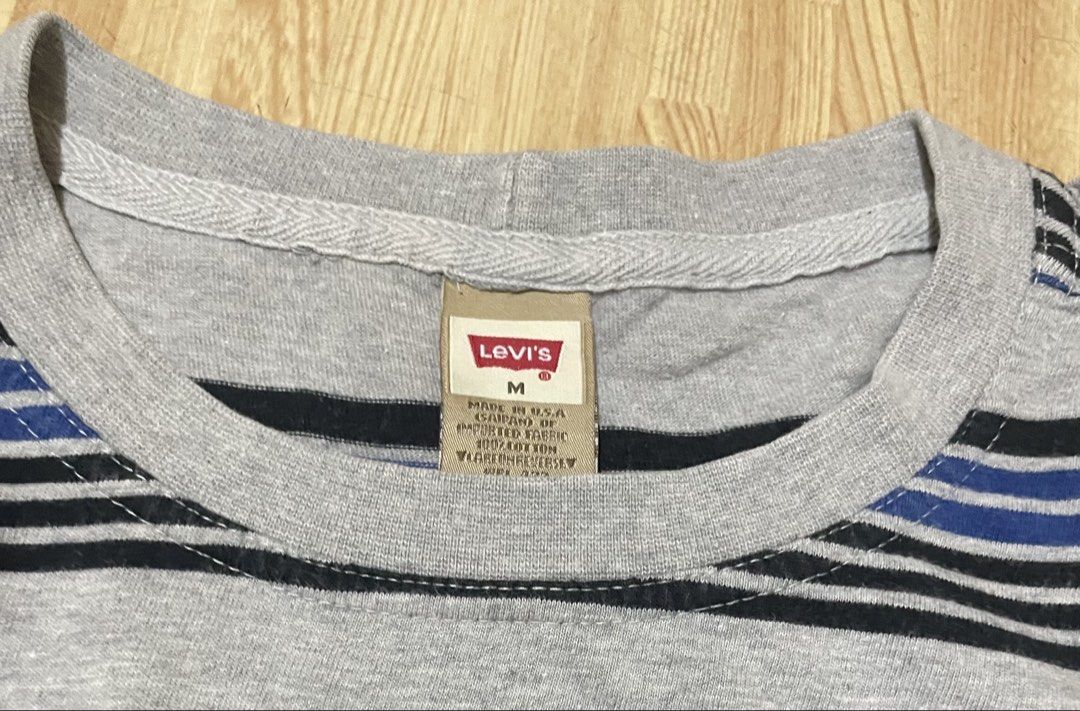 Levi's Grey Striped T-Shirt Size M (Category: Tshirts & Polo Shirts ) located in Caloocan City. Submitted by jetcon (Listing ID 1444185078, Image 2). Description: - Authentic Levi's Grey T-Shirt - Features horizontal stripes in black and blue - Made in USA - Size: Medium (M) - Measurements: Width 22", Length 30" Gcash payment 1st + SF SF rates: 65 for NCR 85 for Luzon 100 for VisMin.