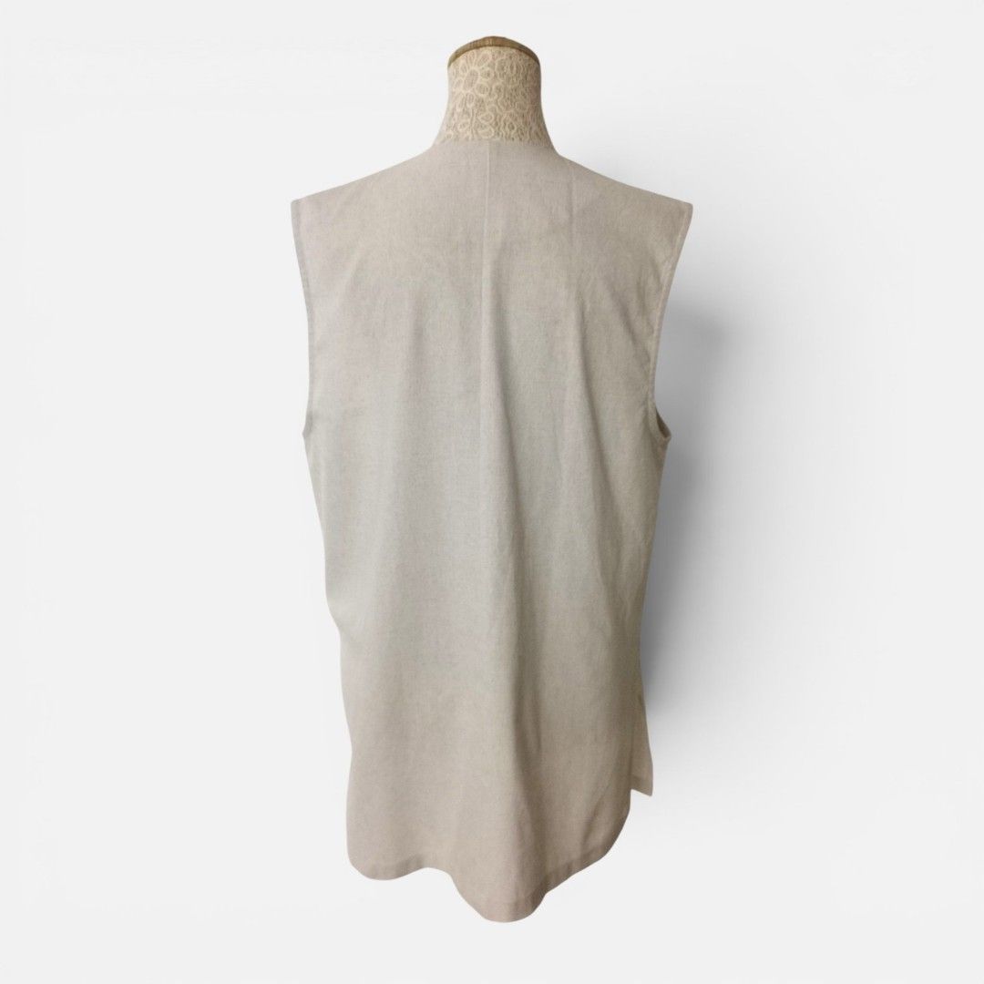 Light Beige V-Neck Sleeveless Vest with Buttons (Category: Sleeveless) located in Mandaue City. Submitted by stylefigjam (Listing ID 1444227439, Image 3). Description: - Simple beige vest - V-neckline - Two-button closure - Two front pockets - Sleeveless - Ideal for layering with shirts or dresses - freesize, can fit up to L body frames.