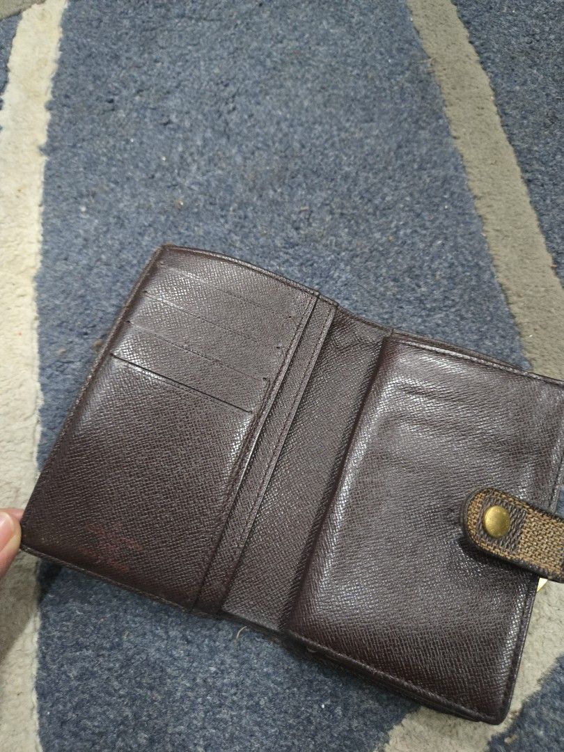 Louis Vuitton Damier Ebene Canvas Wallet (Category: Luxury Bags & Wallets) located in Las Pinas. Submitted by peloveditems (Listing ID 1444256301, Image 2). Description: - Classic Louis Vuitton wallet in Damier Ebene canvas. - Bi-fold design with secure snap closure. - Interior includes multiple card slots. - Features a convenient coin purse with clasp. - Shows some signs of wear on canvas and interior leather. - Still fully functional and stylis