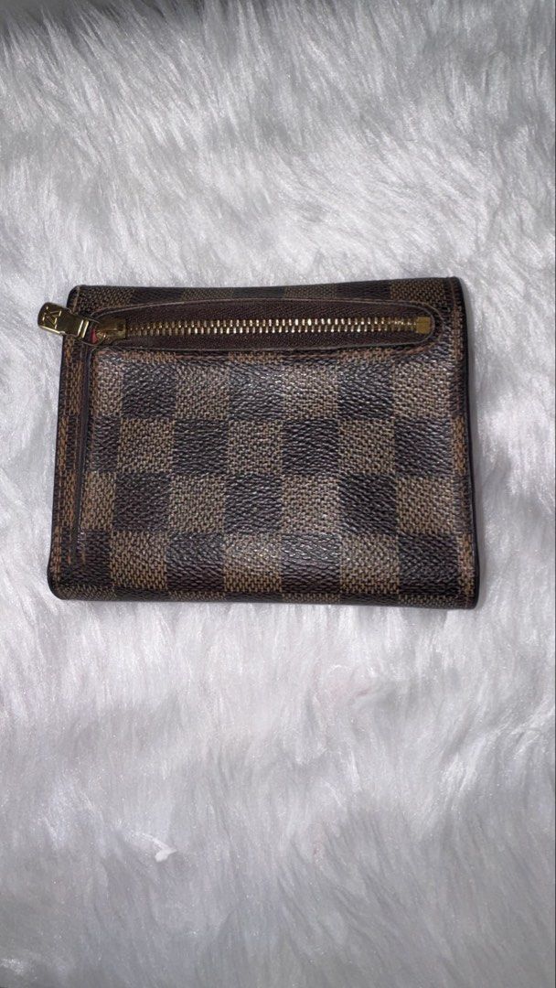 Louis Vuitton Damier Ebene Small Wallet (Category: Luxury Bags & Wallets) located in Taguig. Submitted by almero22 (Listing ID 1444178257, Image 2). Description: - Authentic Louis Vuitton wallet - Damier Ebene canvas with red interior - Includes zip pocket and card slots - Secure clasp closure.