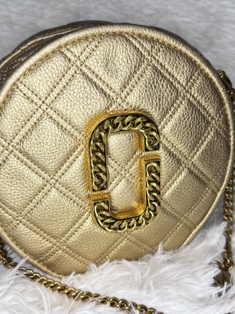 Marc Jacobs The Status Round Crossbody Bag (Category: Luxury Bags & Wallets) located in Cabuyao City. Submitted by velvetbelleph (Listing ID 1444300697, Image 3). Description: Elegant Marc Jacobs The Status Round Crossbody Bag featuring a quilted round silhouette and the signature oversized Double J logo with chain detailing. The neutral metallic beige/champagne color and antique gold-tone hardware make it easy to pair with both casual and dressy
