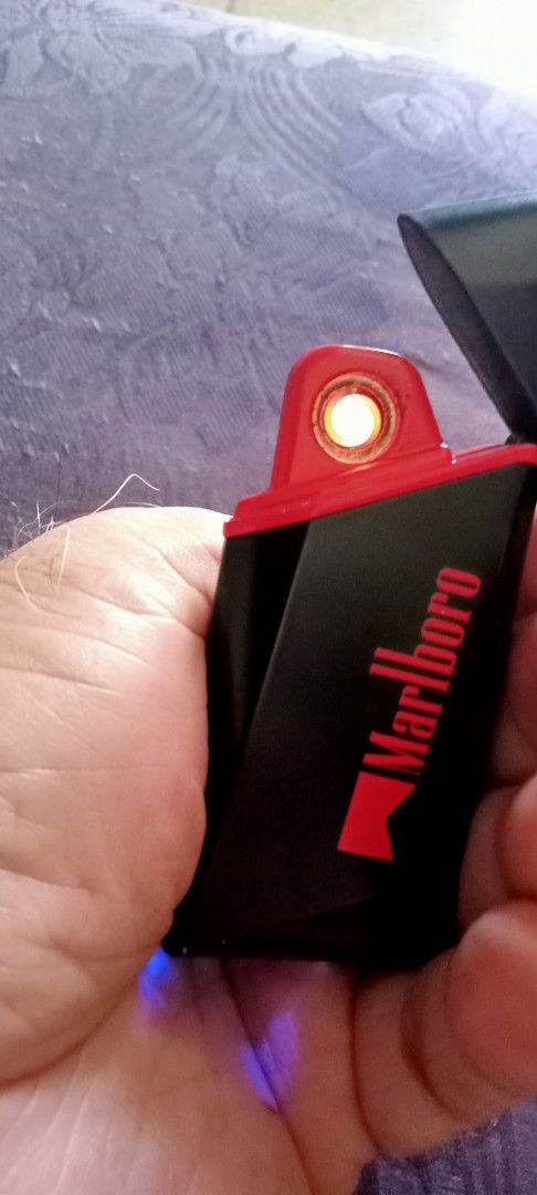 Marlboro Electric Lighter Rechargeable Windproof (Category: Vintage Collectibles) located in Taytay. Submitted by joselaquino (Listing ID 1444125828, Image 3). Description: Rechargeable, windproof Marlboro electric lighter in black and red. Lights with a cool blue glow. Perfect for daily use..