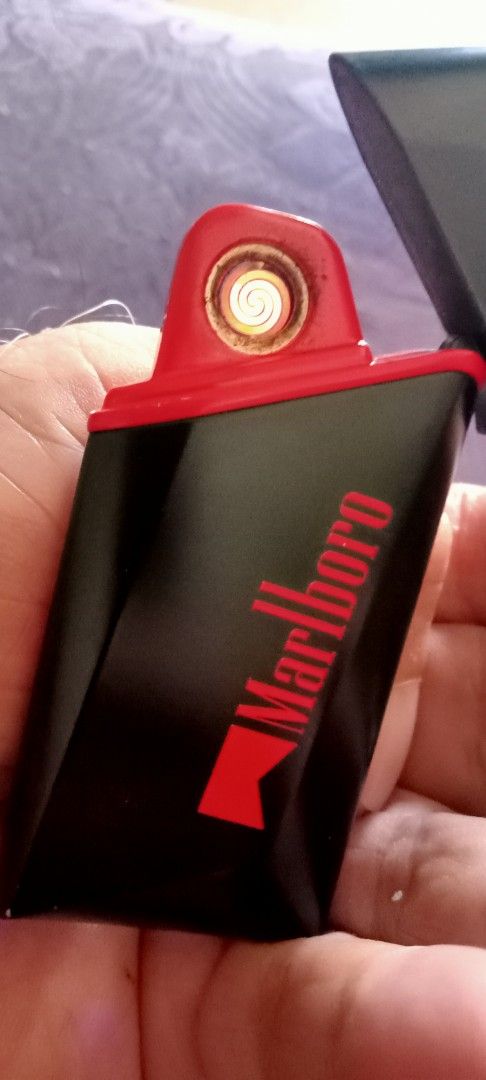 Marlboro Electric Lighter Rechargeable Windproof (Category: Vintage Collectibles) located in Taytay. Submitted by joselaquino (Listing ID 1444125828, Image 1). Description: Rechargeable, windproof Marlboro electric lighter in black and red. Lights with a cool blue glow. Perfect for daily use..