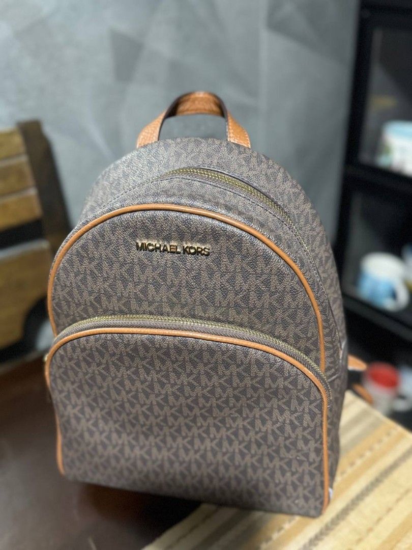 Michael Kors Signature Monogram Backpack (Category: Luxury Bags & Wallets) located in Cavite. Submitted by _lunabanana (Listing ID 1444261854, Image 1). Description: Authentic Michael Kors Abbey Medium Backpack (Preloved) Looking for a stylish and durable everyday bag? Selling my original MK Abbey Backpack in Signature Brown monogram. 🤎 Super ganda at classy sa personal! Smooth zippers, malinis ang loob at labas. Minimal signs of use but overall