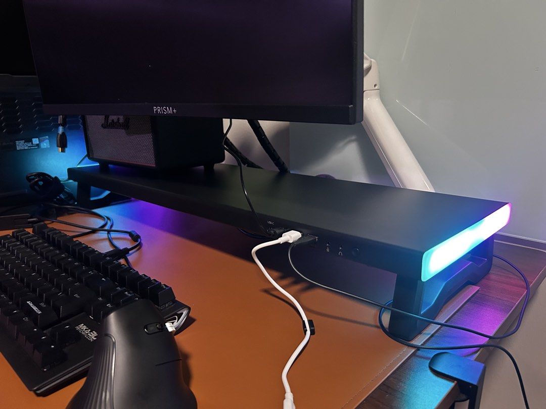 Monitor riser docking hub (Category: Computer Keyboard) located in Singapore. Submitted by heyhowsitgoing (Listing ID 1444245059, Image 2). Description: - 75 cm x 23 cm monitor riser - Integrated RGB lighting - Can use as docking station if main USB cable is connected to your device - Ports: 2 USB, 1 type C and audio + mic jack with adapter - Sturdy metal and ABS construction - Supports up to 70kg weight capacity - Helps organize your desk space 