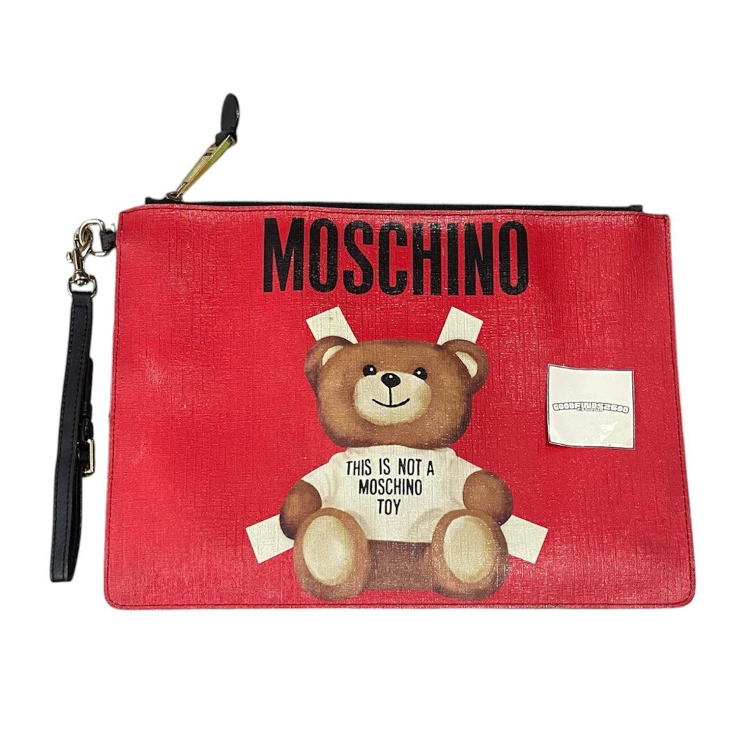 Moschino Saffiano Leather Clutch Pouch (Category: Luxury Bags & Wallets) located in Baguio. Submitted by goodfinds2600v2 (Listing ID 1444267797, Image 1). Description: Size on tag: Dimensions: L- W- Description: Condition: Very good Issue/s: signs of usage, light fade on leather(some parts), needs replacement on wrist handle attachment .