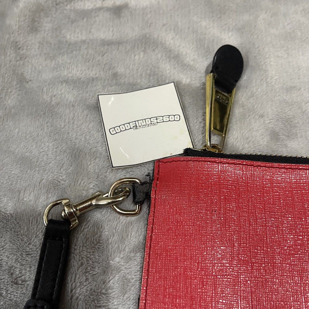 Moschino Saffiano Leather Clutch Pouch (Category: Luxury Bags & Wallets) located in Baguio. Submitted by goodfinds2600v2 (Listing ID 1444267797, Image 3). Description: Size on tag: Dimensions: L- W- Description: Condition: Very good Issue/s: signs of usage, light fade on leather(some parts), needs replacement on wrist handle attachment .