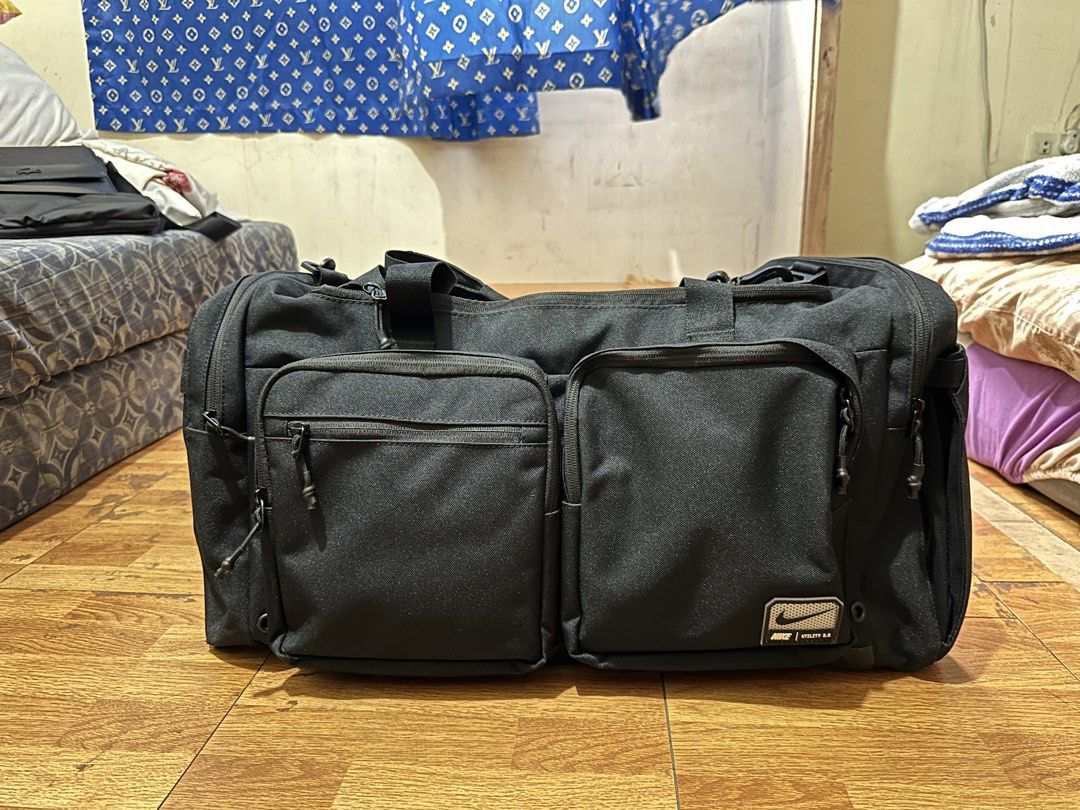 Nike Utility 2.0 Black Duffel Bag (51L) (Category: Sling Bags) located in Manila. Submitted by vench02jua72322 (Listing ID 1444292079, Image 1). Description: - Nike Utility 2.0 Duffel Bag 51L - Multiple front pockets for easy access - Spacious main compartment - Separate insulated compartment (perfect for gym/travel) - Durable material - Includes handles and adjustable shoulder strap.