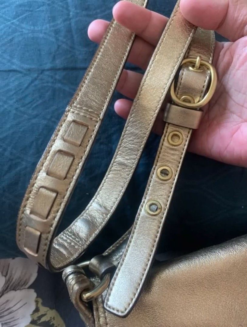 Original Coach Signature Gold Leather (Category: Luxury Bags & Wallets) located in Manila. Submitted by leontheexplorer (Listing ID 1444138379, Image 3). Description: - Original Coach sling bag - Classic monogram canvas with gold leather accents - Two front pockets with buckle closures - Interior zippered pocket - Adjustable strap - Comes with original tag.
