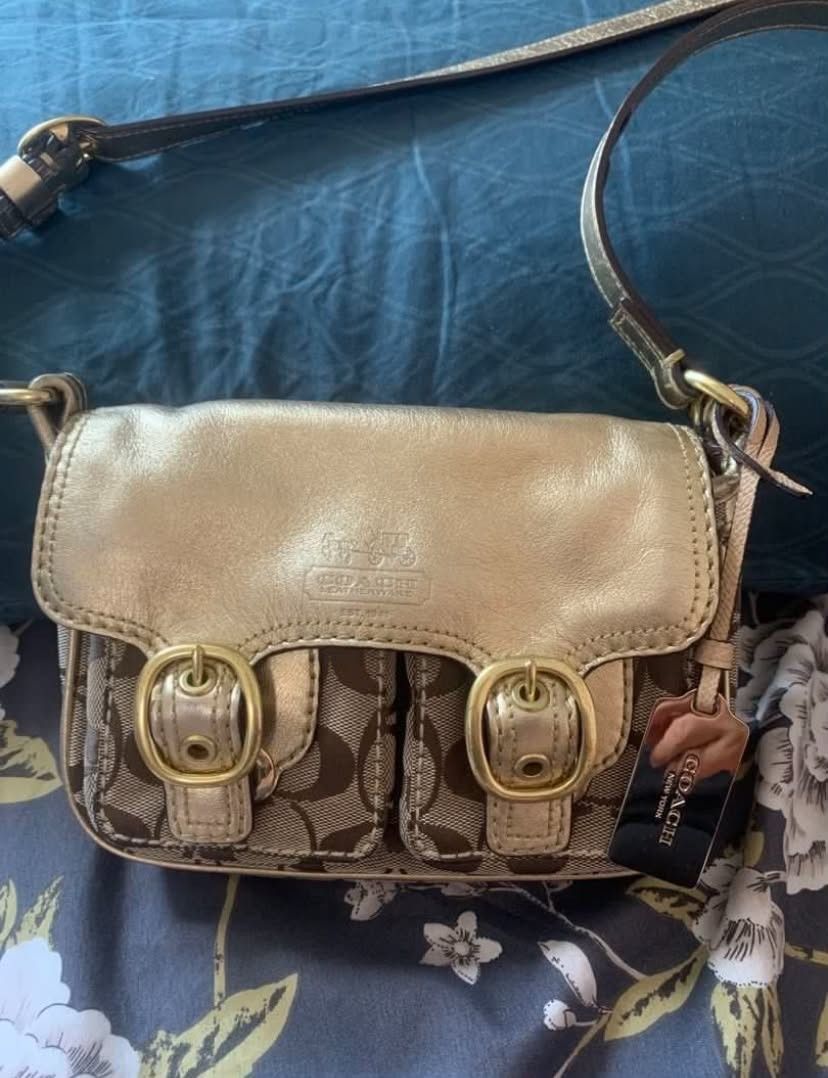 Original Coach Signature Gold Leather (Category: Luxury Bags & Wallets) located in Manila. Submitted by leontheexplorer (Listing ID 1444138379, Image 2). Description: - Original Coach sling bag - Classic monogram canvas with gold leather accents - Two front pockets with buckle closures - Interior zippered pocket - Adjustable strap - Comes with original tag.