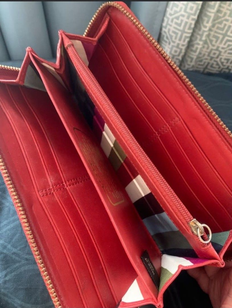 Original Coach Signature Zip Around Wallet (Payday Sale) (Category: Luxury Bags & Wallets) located in Manila. Submitted by leontheexplorer (Listing ID 1444140872, Image 2). Description: - Original Coach signature canvas wallet - Stylish coral stripe detail - Rich red leather interior - Multiple card slots for organization - Convenient zippered coin pocket - Elegant gold-tone hardware and zipper - Includes original Coach gold charm - Flaw: Gold ch