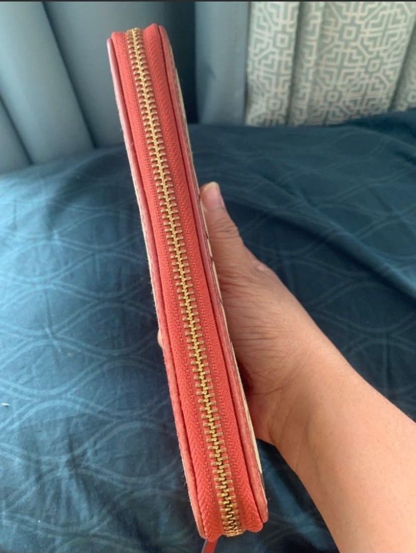 Original Coach Signature Zip Around Wallet (Payday Sale) (Category: Luxury Bags & Wallets) located in Manila. Submitted by leontheexplorer (Listing ID 1444140872, Image 3). Description: - Original Coach signature canvas wallet - Stylish coral stripe detail - Rich red leather interior - Multiple card slots for organization - Convenient zippered coin pocket - Elegant gold-tone hardware and zipper - Includes original Coach gold charm - Flaw: Gold ch