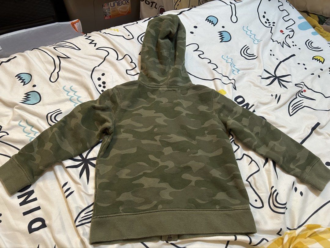 OshKosh Camouflage Jacket Hoodie, 4y (Category: Babies & Kids Fashion) located in Paranaque City. Submitted by allthatclutterph (Listing ID 1444176702, Image 2). Description: - OshKosh camo zip-up hoodie (Size 4) with navy lined hood Very good condition as seldom used.