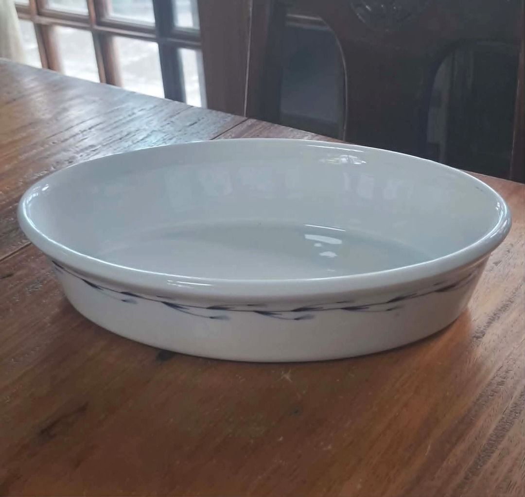 Oval Ceramic Serving Dish / Baking Dish – Preloved (Category: Bakeware) located in Quezon City. Submitted by m_decluttering_sale (Listing ID 1444183293, Image 1). Description: Oval Ceramic Serving Dish / Baking Dish – Preloved Description: Elegant white oval ceramic serving dish in very good pre-owned condition. Features a subtle blue decorative pattern around the side. Perfect for serving pasta, vegetables, baked dishes, casseroles, desserts, or