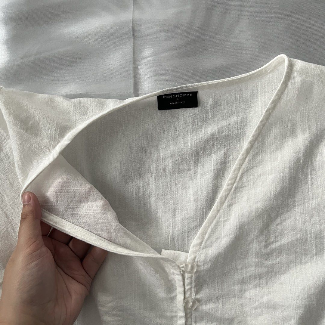 PENSHOPPE Puff Sleeve Blouse Top (Category: Blouses) located in Antipolo. Submitted by lacekeepsakes (Listing ID 1444190631, Image 3). Description: 🌷 condition: good, previously used. 🌷 design details: front tie details; peplum hem; smocked/elasticized waist;puff sleeves 🌷 fabric: likely woven cotton blend or rayon-cotton blend 🌷 material: not confirmed from available sources 🌷 color: off-white 🌷 size: large 🌷 issues/flaws: none observed t