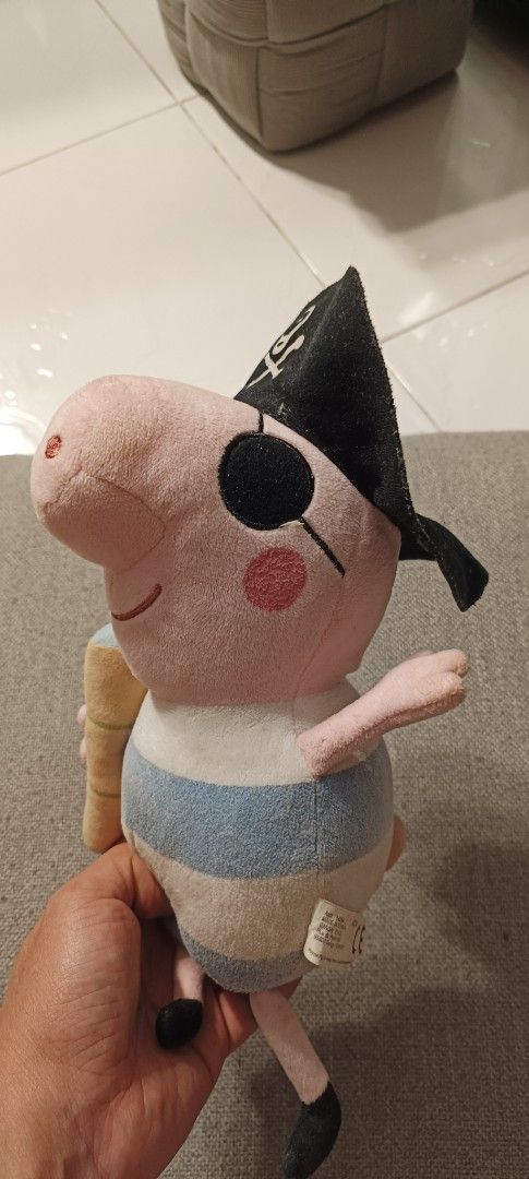 Peppa Pig Pirate Plush Toy with Eye Patch (Category: Plushies & Soft Toys) located in Manila. Submitted by deeclutter_hub (Listing ID 1444240371, Image 2). Description: - Adorable Peppa Pig plush toy dressed as a pirate. - Features a pirate hat with skull and crossbones. - Includes an eye patch for authentic pirate look. - Blue and white striped shirt. - Holding a yummy yellow ice cream cone. - A must-have for any Peppa Pig enthusiast!.