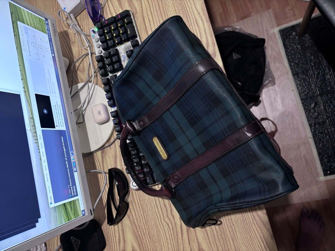 Polo Ralph Lauren Plaid Duffle Bag (Category: Luxury Bags & Wallets) located in Manila. Submitted by harveyyay07523 (Listing ID 1444205041, Image 1). Description: - Vintage Polo Ralph Lauren duffle bag - Classic green and navy plaid pattern - Genuine leather trim and handles - Secure zipper closure - Ideal for weekend getaways or gym sessions - Minor signs of wear on zipper and leather, consistent with age - Timeless and stylish accessory.