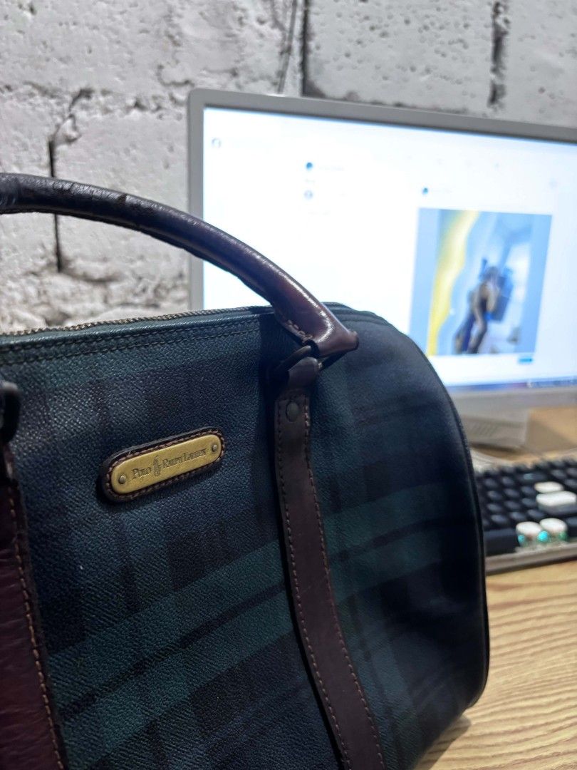 Polo Ralph Lauren Plaid Duffle Bag (Category: Luxury Bags & Wallets) located in Manila. Submitted by harveyyay07523 (Listing ID 1444205041, Image 3). Description: - Vintage Polo Ralph Lauren duffle bag - Classic green and navy plaid pattern - Genuine leather trim and handles - Secure zipper closure - Ideal for weekend getaways or gym sessions - Minor signs of wear on zipper and leather, consistent with age - Timeless and stylish accessory.