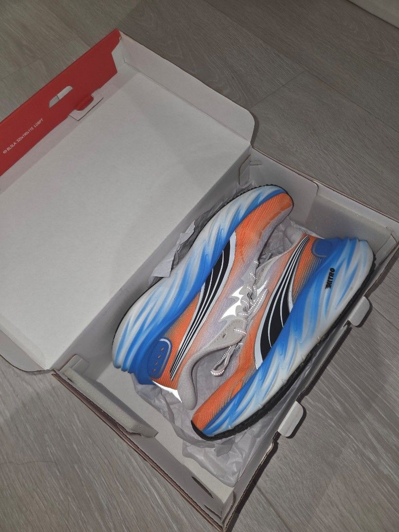 Puma velocity nitro 4 - White/Orange/Blue (Category: Sneakers) located in Pasig City. Submitted by igotchugirl (Listing ID 1444177104, Image 1). Description: - Puma running shoes - Color: White with orange and blue accents - Laces: Grey worn once - Condition: Worn Once - Includes original box - Ideal for running.