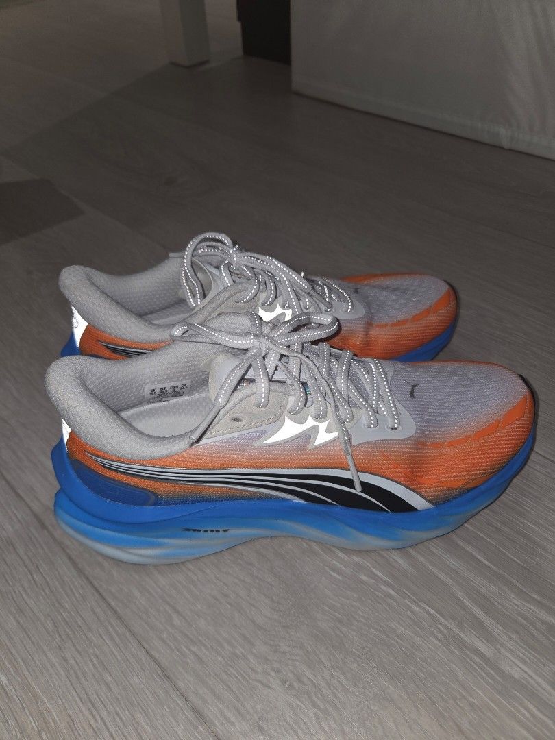 Puma velocity nitro 4 - White/Orange/Blue (Category: Sneakers) located in Pasig City. Submitted by igotchugirl (Listing ID 1444177104, Image 2). Description: - Puma running shoes - Color: White with orange and blue accents - Laces: Grey worn once - Condition: Worn Once - Includes original box - Ideal for running.